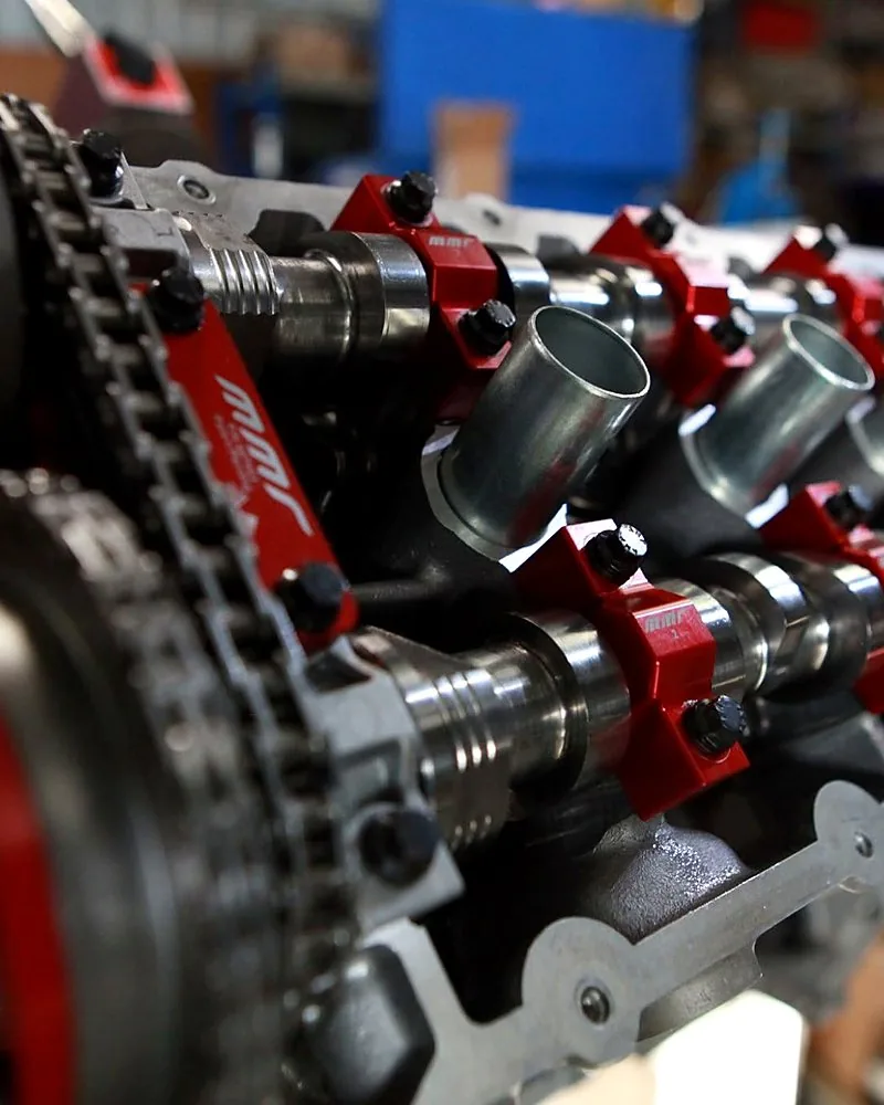 Camshaft dial-in — degree wheel and dial indicator verifying installed cam timing against the cam card on the cylinder head