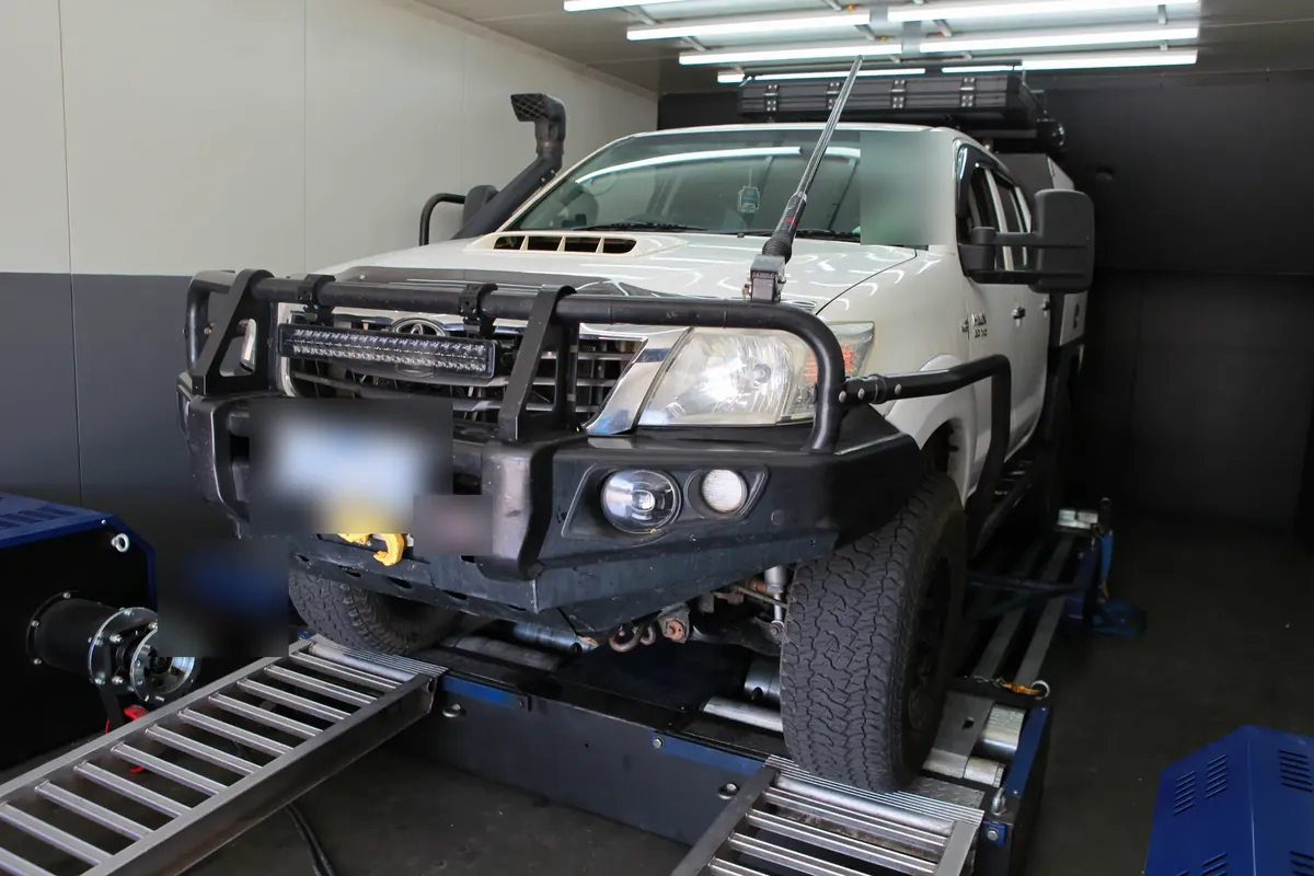 Turbo-diesel 4WD ute strapped to a chassis dyno for calibration development
