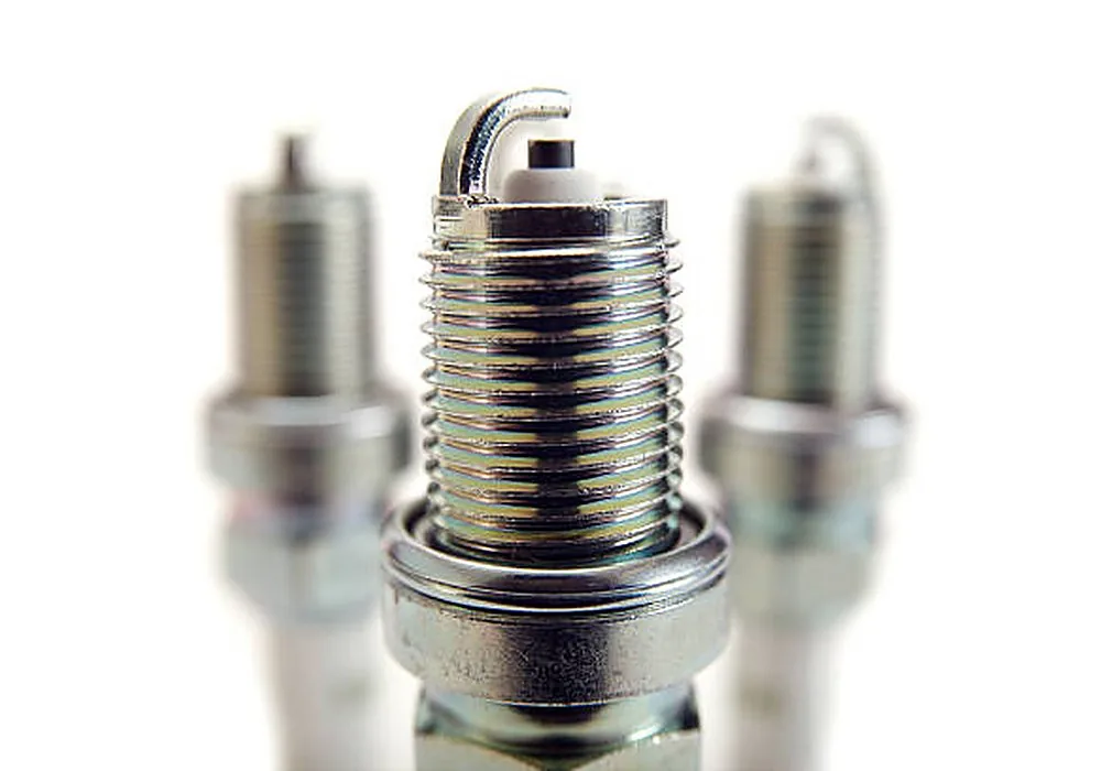 Spark plug ground strap rear view — pre-ignition and heat soak indicators