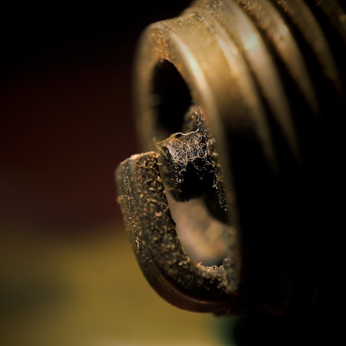 Spark plug ground strap rear view — pre-ignition and heat soak indicators